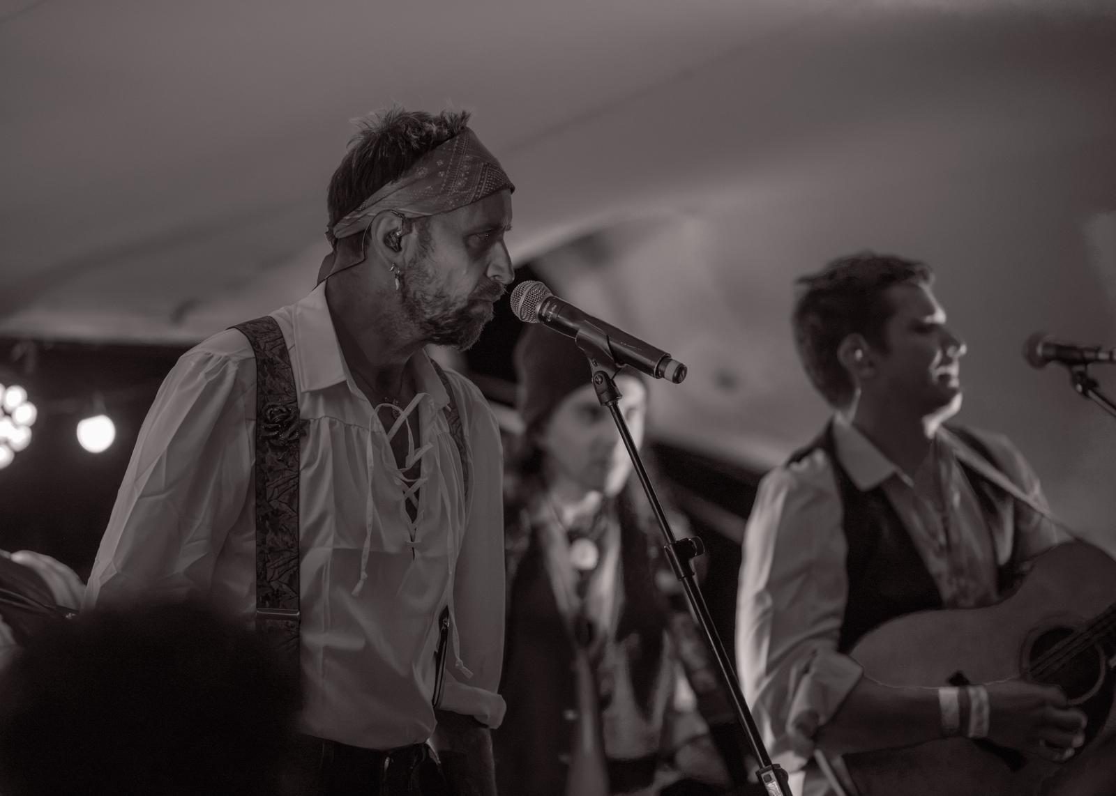 Two shipmates singing together, one with a guitar