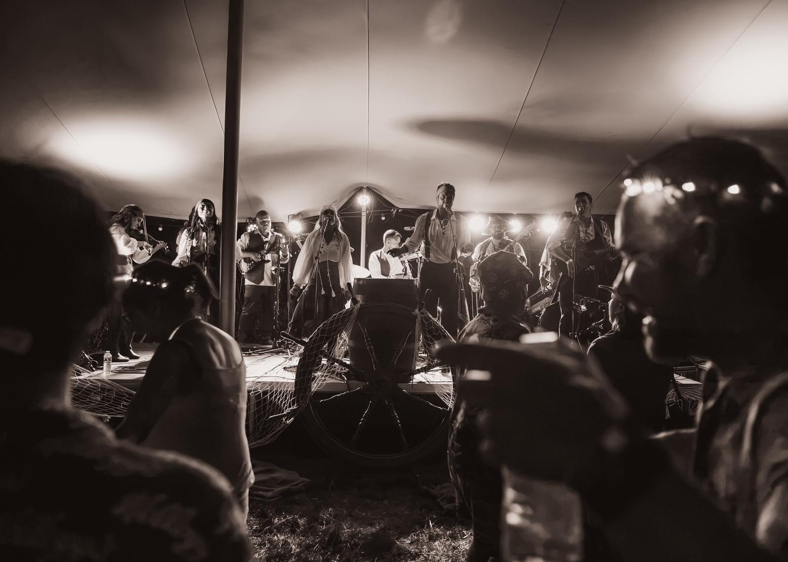 The crowd watching the band from the back of the tent